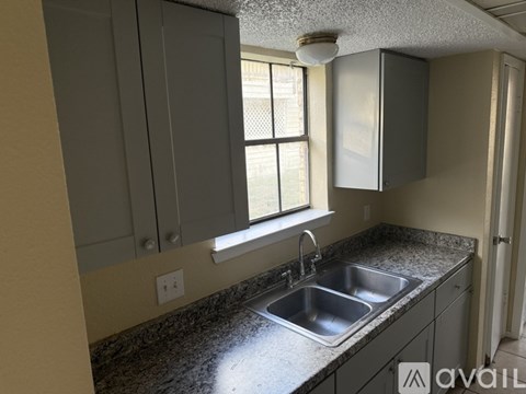 A kitchen with a sink and cabinets.