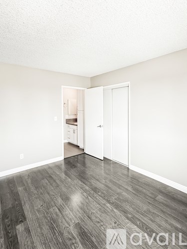 A room with a white door and a white wall.