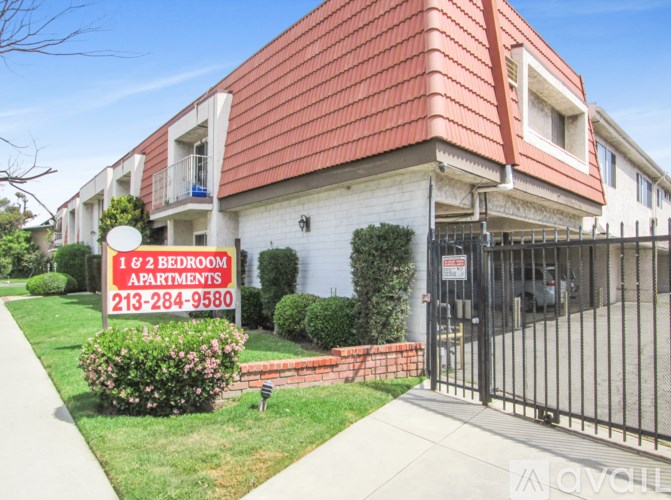 A sign in front of a building advertises 1 and 2 bedroom apartments.