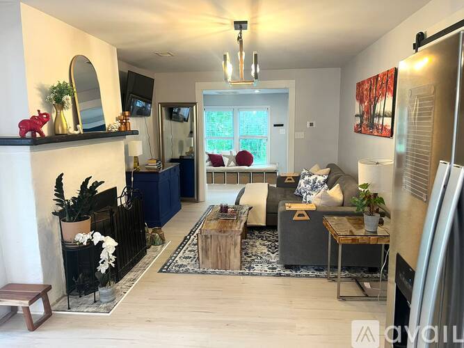 A living room with a dark blue couch and a wooden coffee table.
