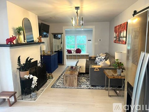 A living room with a dark blue couch and a wooden coffee table.