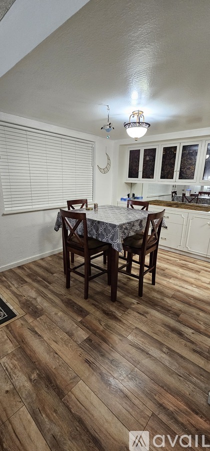 A kitchen with a table and chairs in the middle of the room.