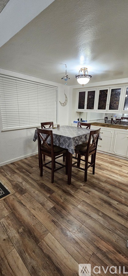 A kitchen with a table and chairs in the middle of the room.