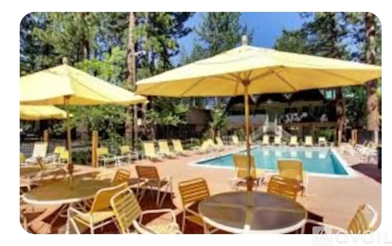 A poolside area with yellow umbrellas and chairs.