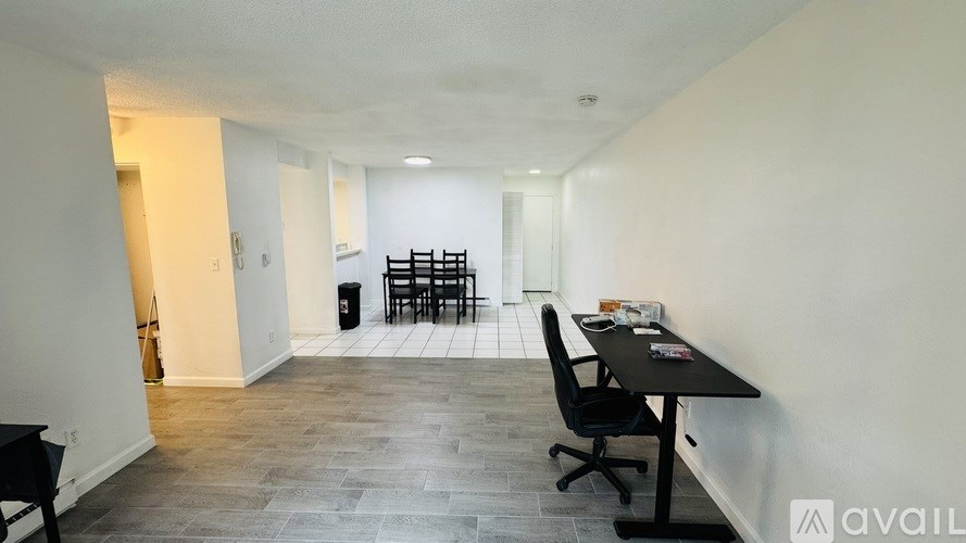 A room with a desk and chairs.