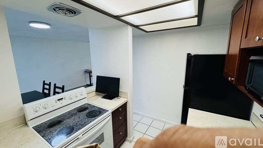 A kitchen with a stove, microwave, and refrigerator.