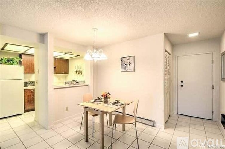 A dining room with a table set for two.