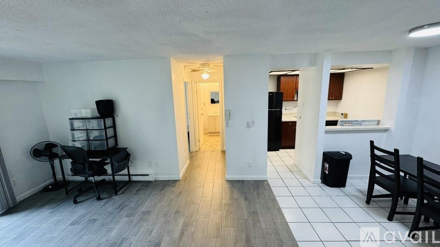 A room with a chair and a table in it.