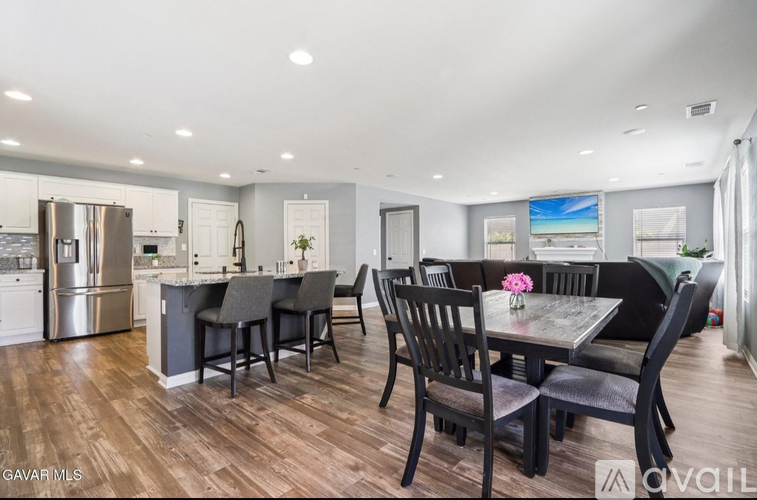 A modern kitchen with a dining table set for four.