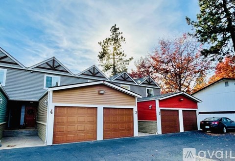 A house with a car parked in front of it.