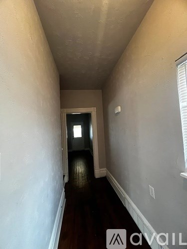 A long hallway with a door at the end.