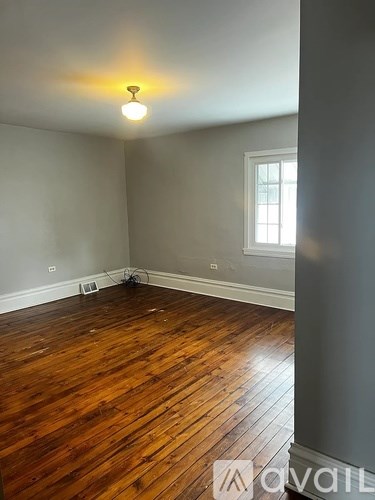A room with wooden floors and a light on.
