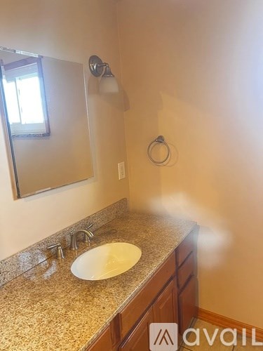 A bathroom with a sink and mirror.