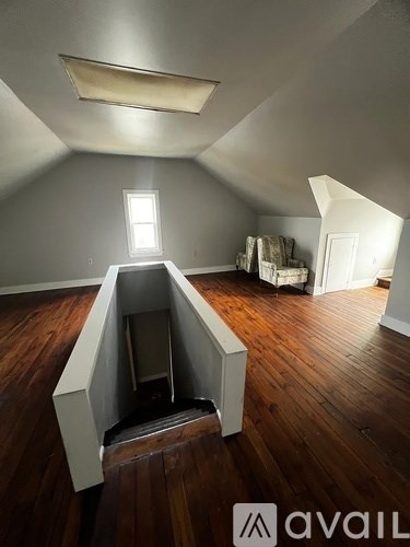 A room with wooden floors and a window.