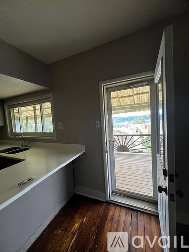 A kitchen with a sink and a window.