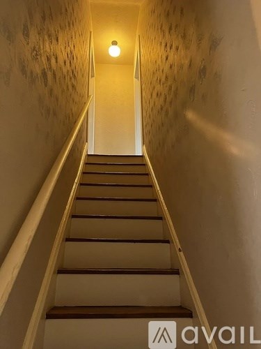 A staircase with a light on at the top.