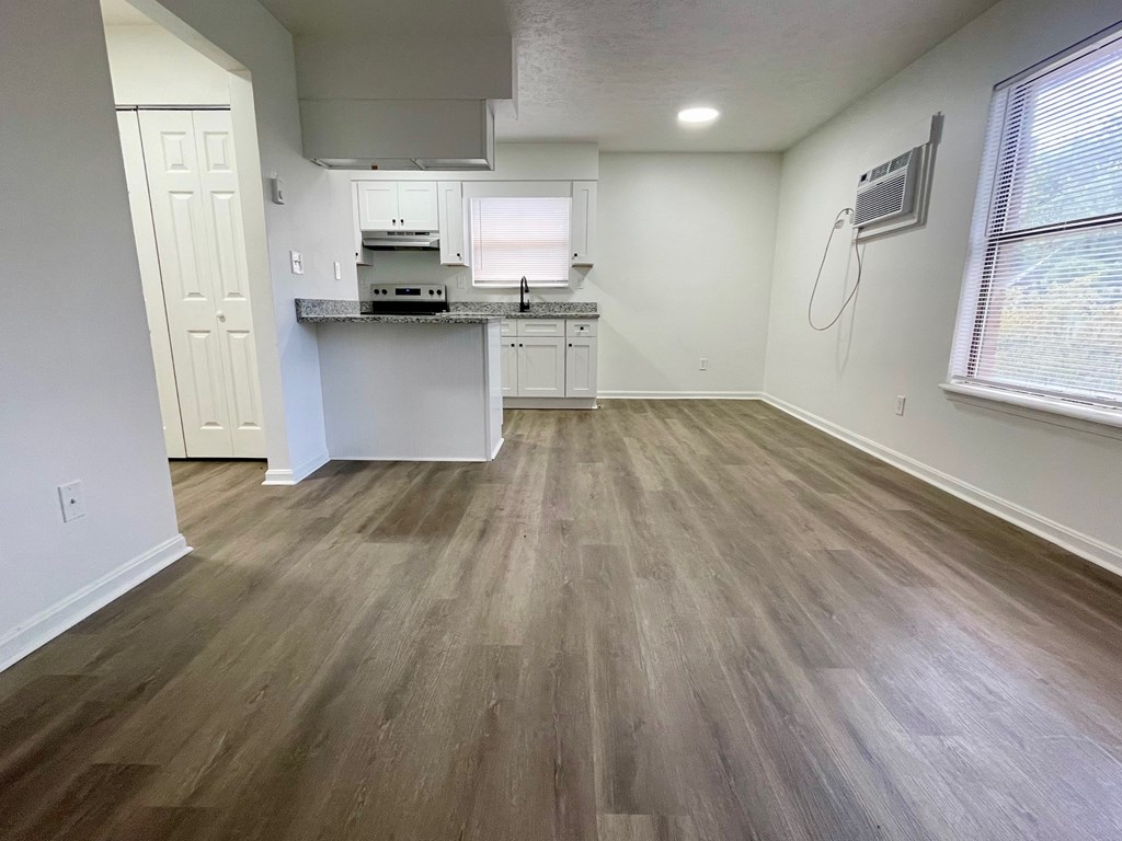 A kitchen with a white countertop and a white oven.