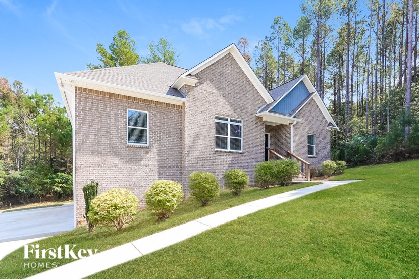 A brick house with a white window and a small porch.