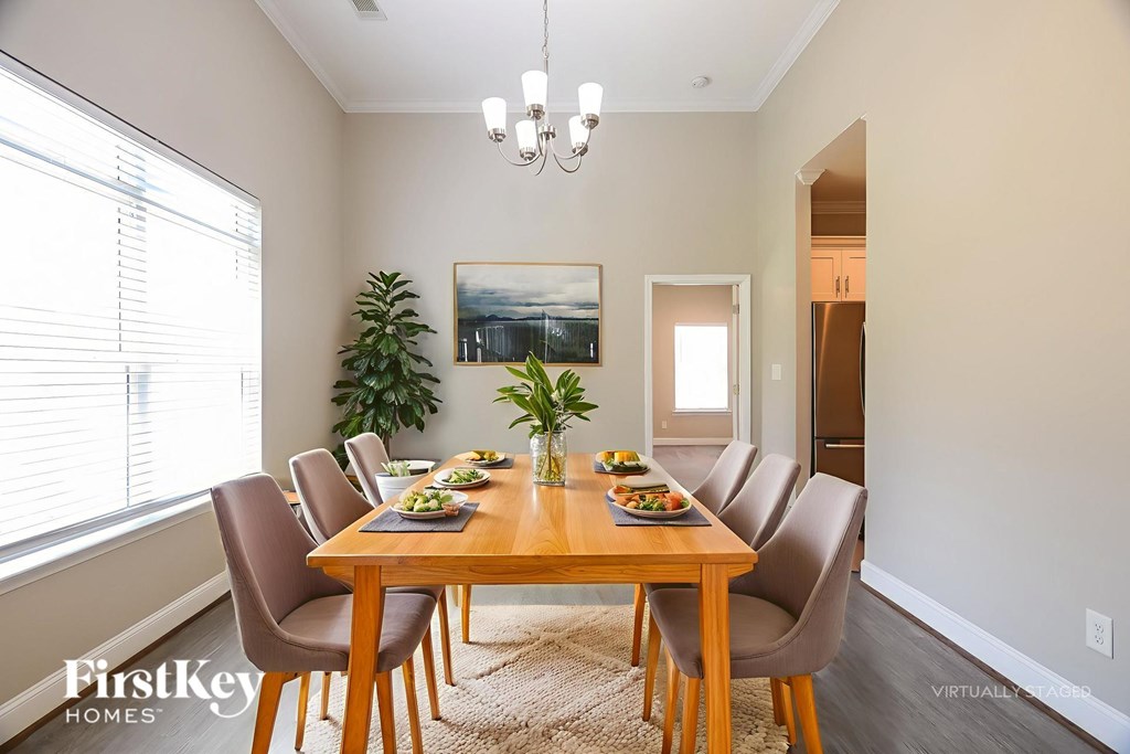 A dining room with a wooden table and chairs.