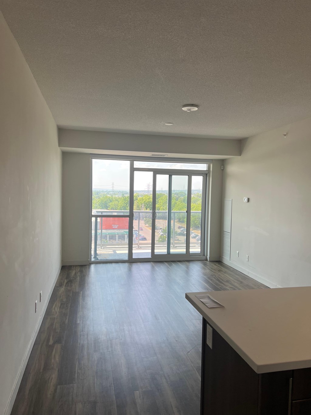 A room with a sliding glass door leading to a balcony.