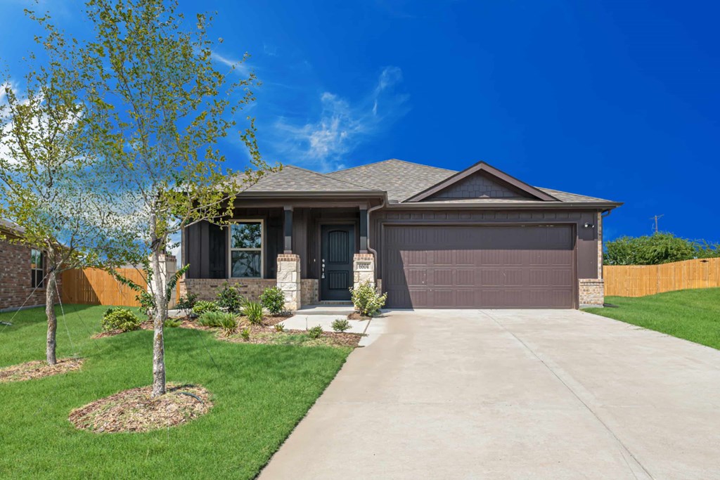 A house with a brown garage door and a driveway.