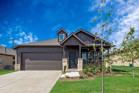 A house with a brown garage door and a grey door.