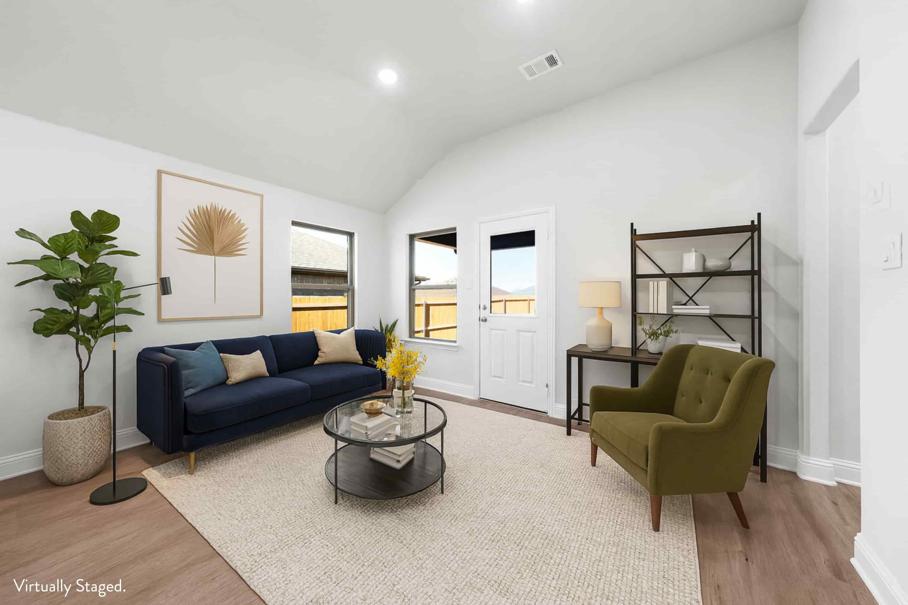 A living room with a blue couch, a green armchair, and a coffee table.