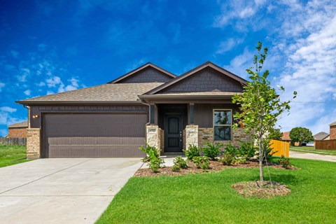 A house with a brown garage door and a black front door.