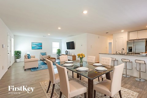 A dining room with a glass table and chairs.