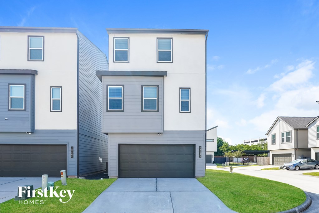 A modern two-story house with a garage is for sale by FirstKey Homes.