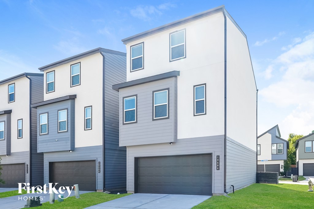 A modern two-story house with a garage is showcased.