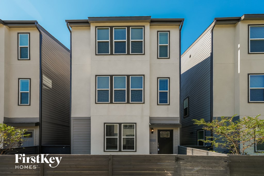 A modern building with the sign "FirstKey Homes" in front of it.