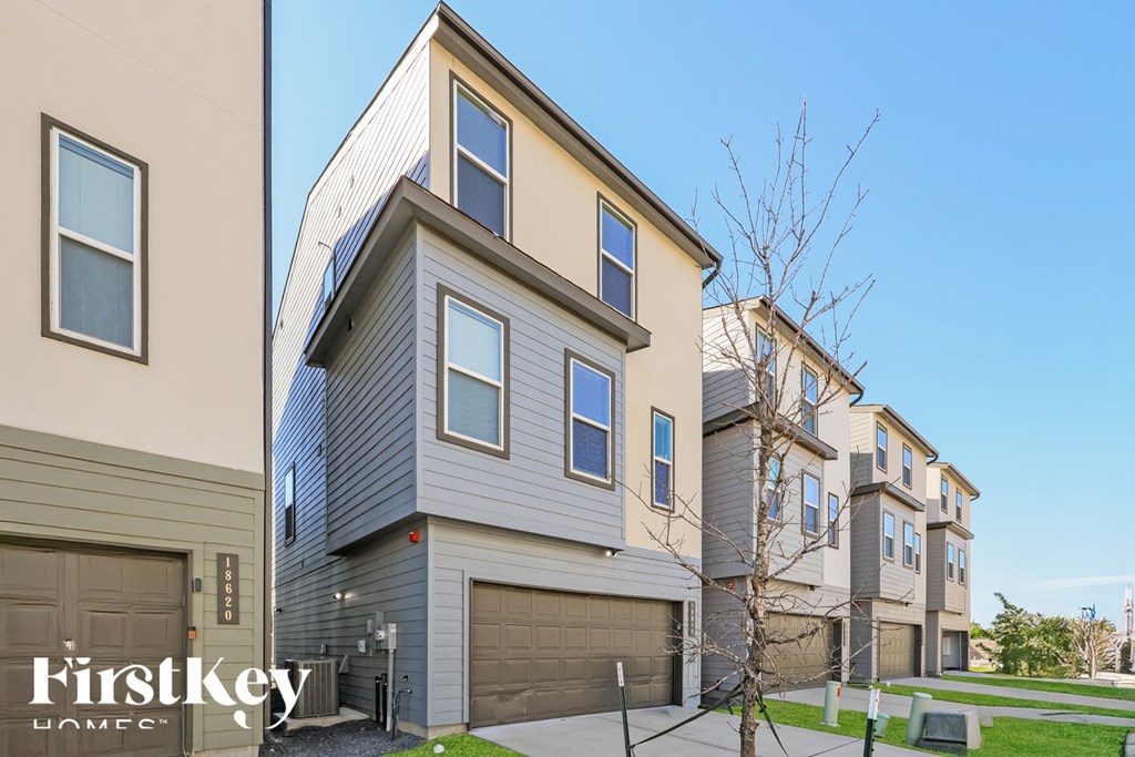A row of houses with the words "FirstKey Homes" on the first one.