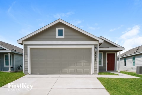 A house with a garage door and a red door is for sale.