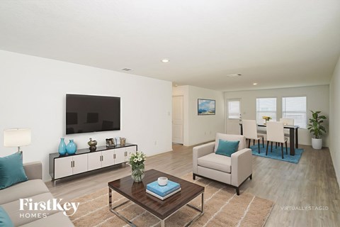 A living room with a brown coffee table and a white couch.
