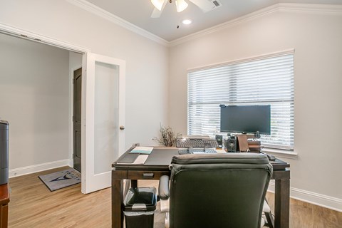 A home office with a desk, chair, and computer.