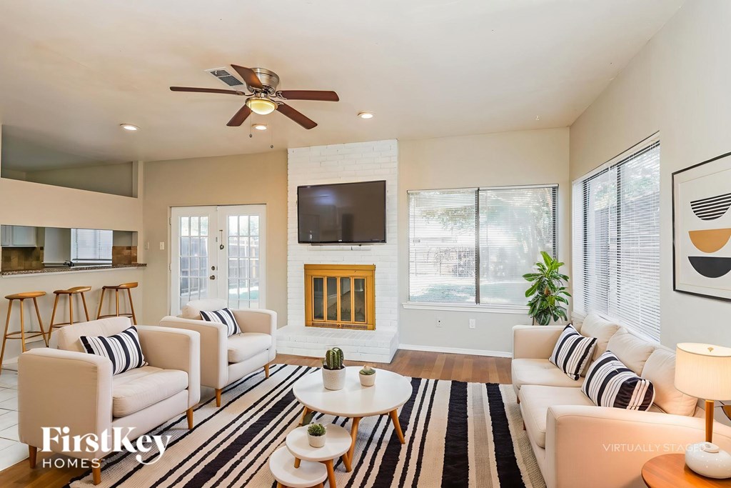 A living room with a flat screen TV and a fireplace.