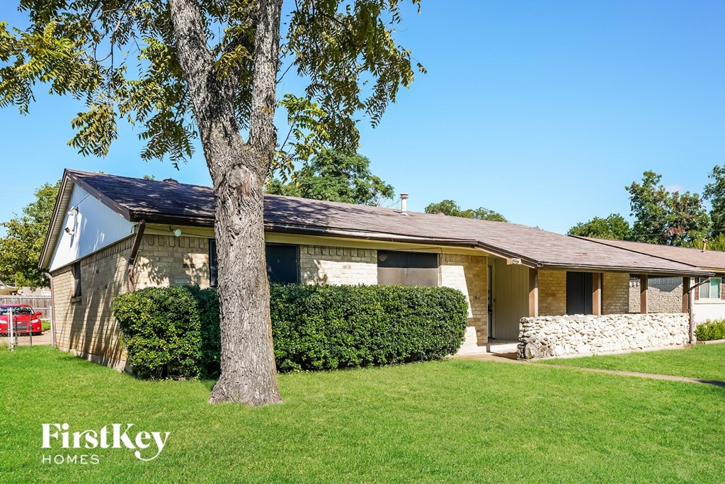 A house with a tree in front of it.
