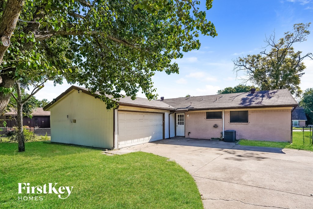 A two-car garage with a white exterior and a brown roof.