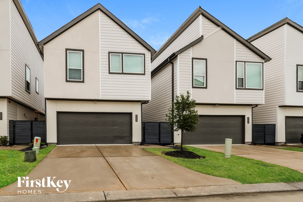 A row of houses with the logo "FirstKey Homes" on the front.
