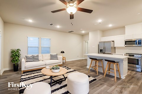 A modern living room with a white couch and a wooden coffee table.