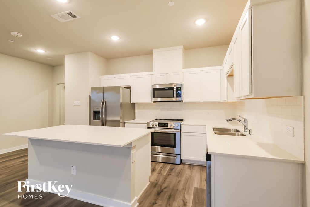 A modern kitchen with a FirstKey Homes logo.