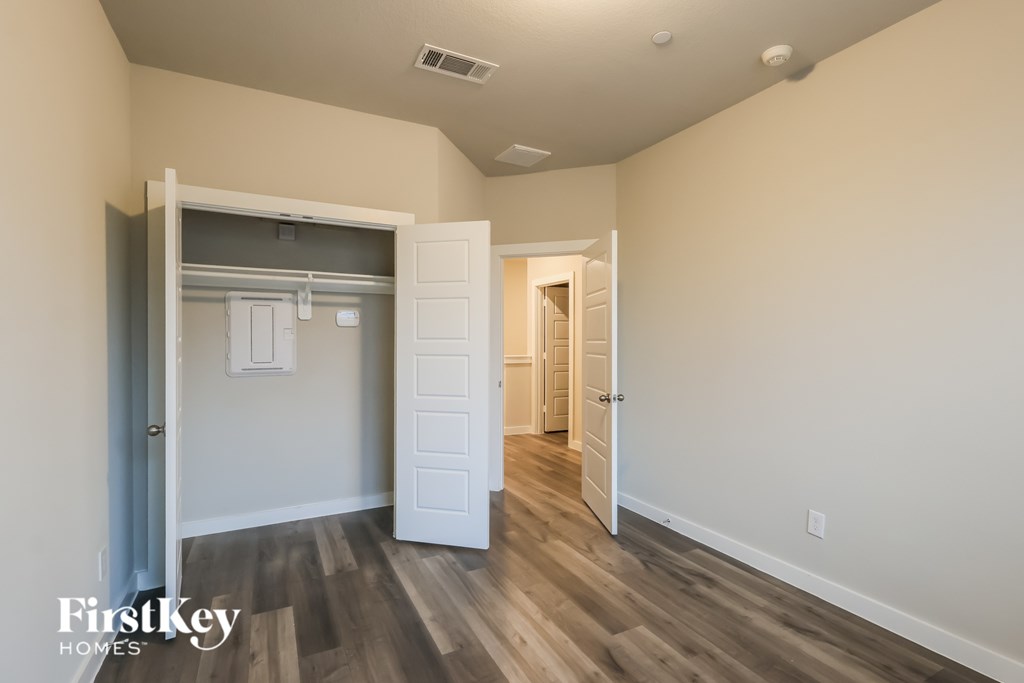 A room with a white door and a white closet with a white door.