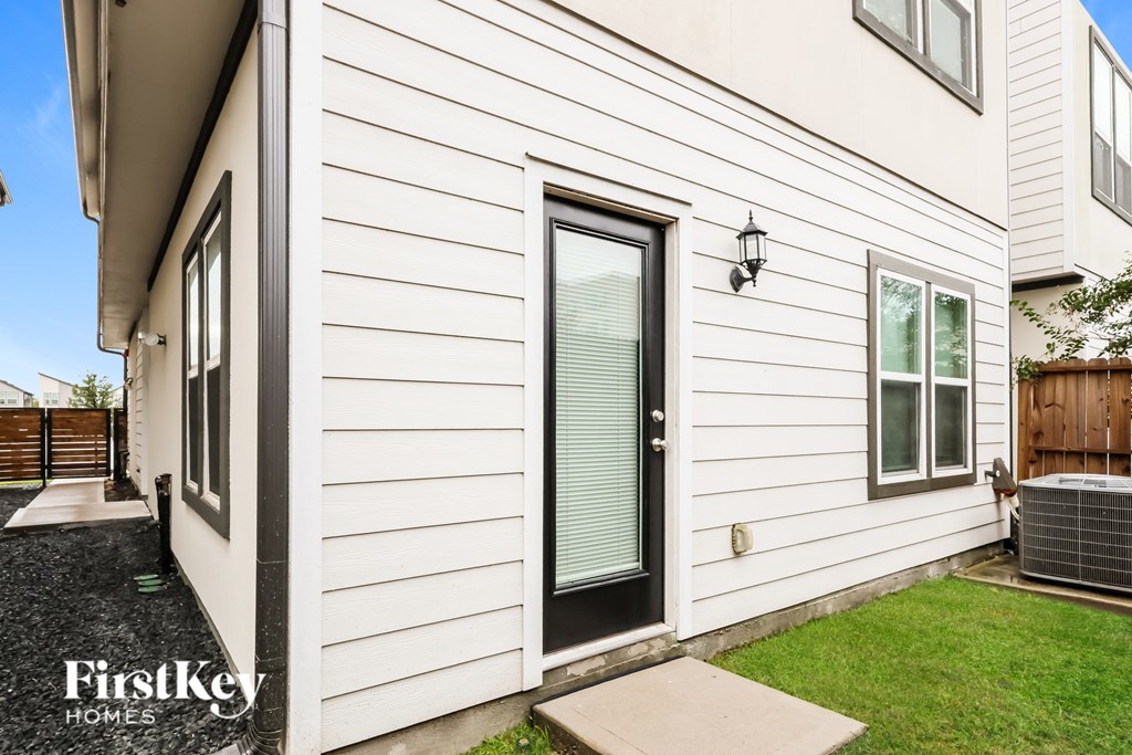 A white house with a black door and a small porch.