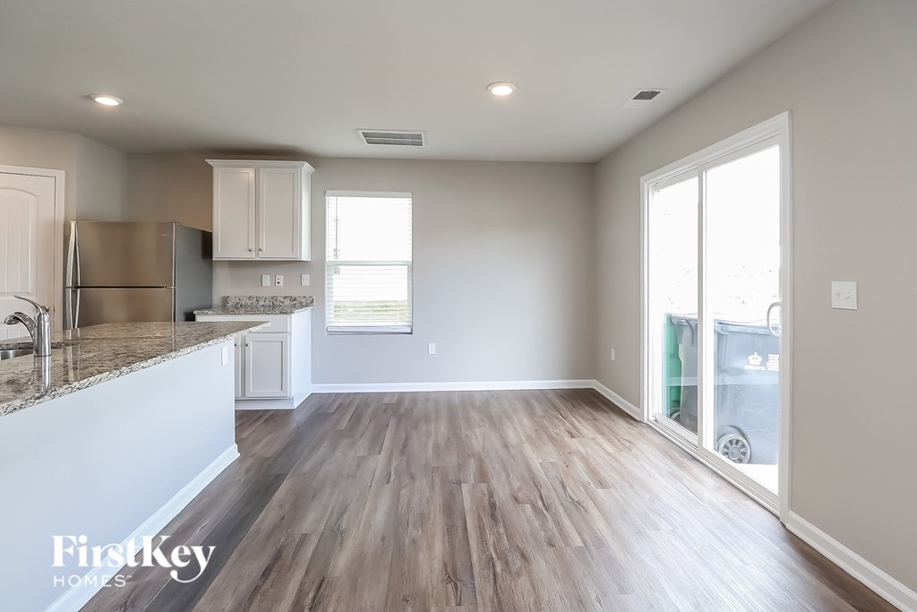 A kitchen with a refrigerator, cabinets, and a countertop.