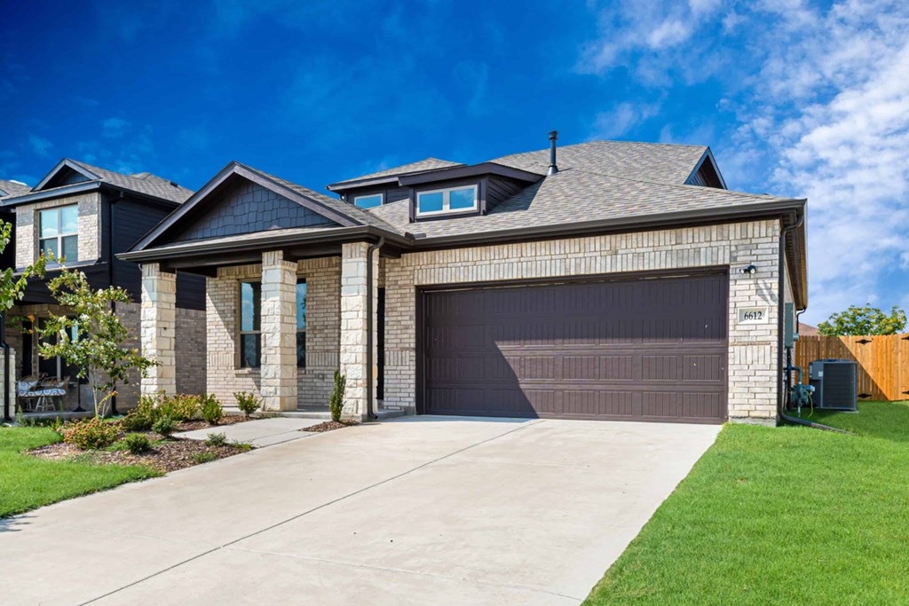 A modern house with a large garage door.