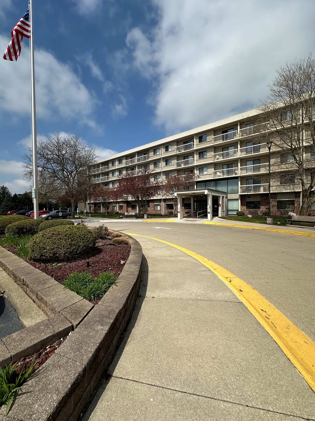A building with a flag on a pole in front of it.