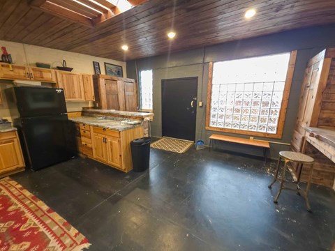 A kitchen with wooden cabinets and black appliances.