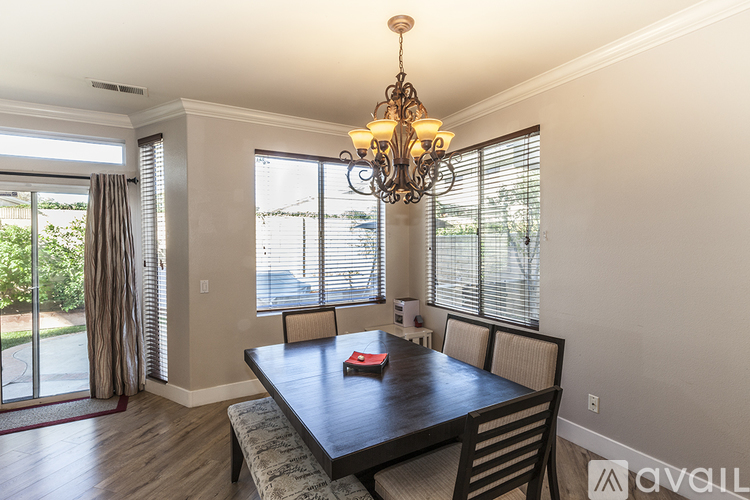 A dining room with a wooden table and chairs.