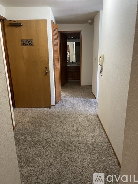 A hallway with a door numbered 802.